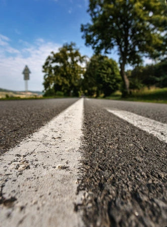 Yamaha Tracer 9 GT on a curved road through the Monferrato hills, Piedmont, Italy